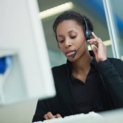 Photo of a female hotline respondent wearing a headset