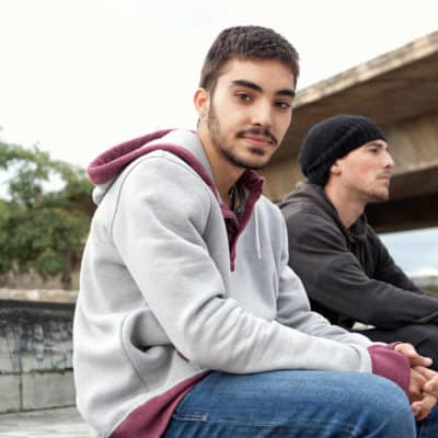 Photo of teenage men sititng near an underpass