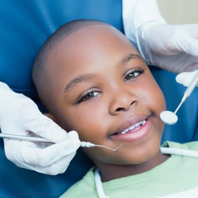 Photo of a young boy having his teeth cleaned at the Dentist