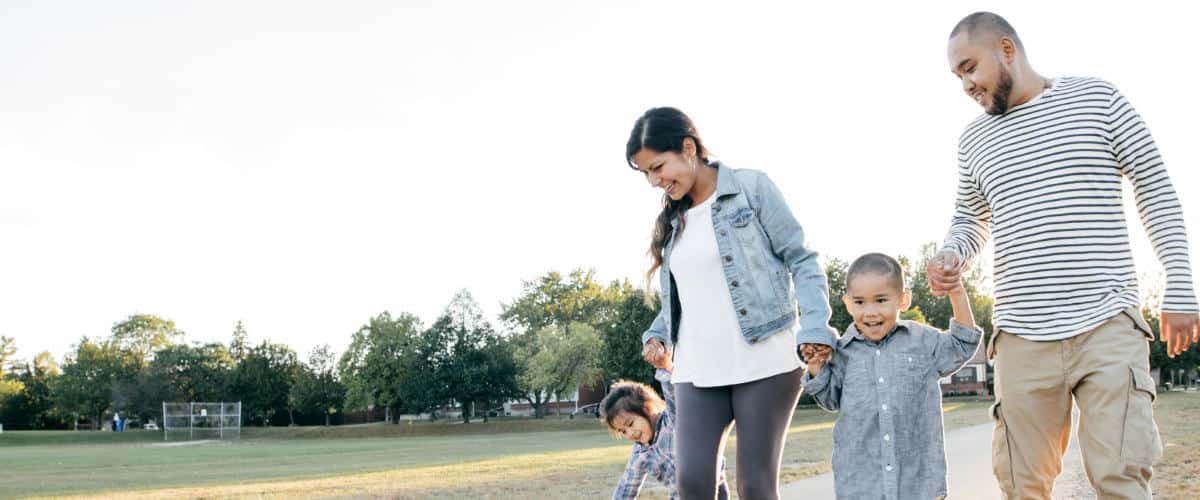 Photo of a hispanic family walking through a park