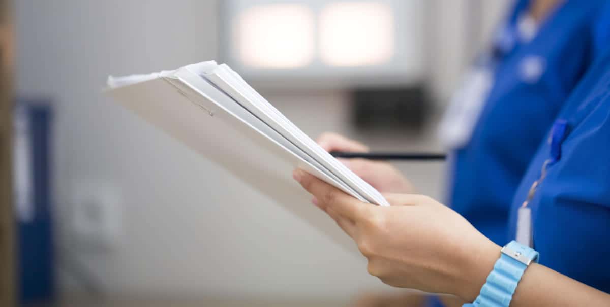 Photo of a Doctor holding papers