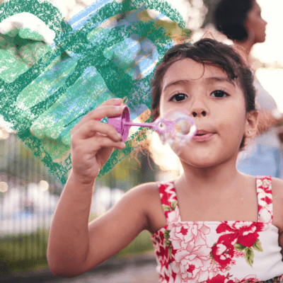small child blowing bubbles with PCH Logo in the background expressing childhood grief