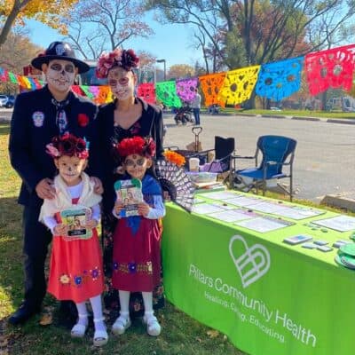 Family at the Pillars Community Health Information Table at the Western Springs Park District's Halloween Bash
