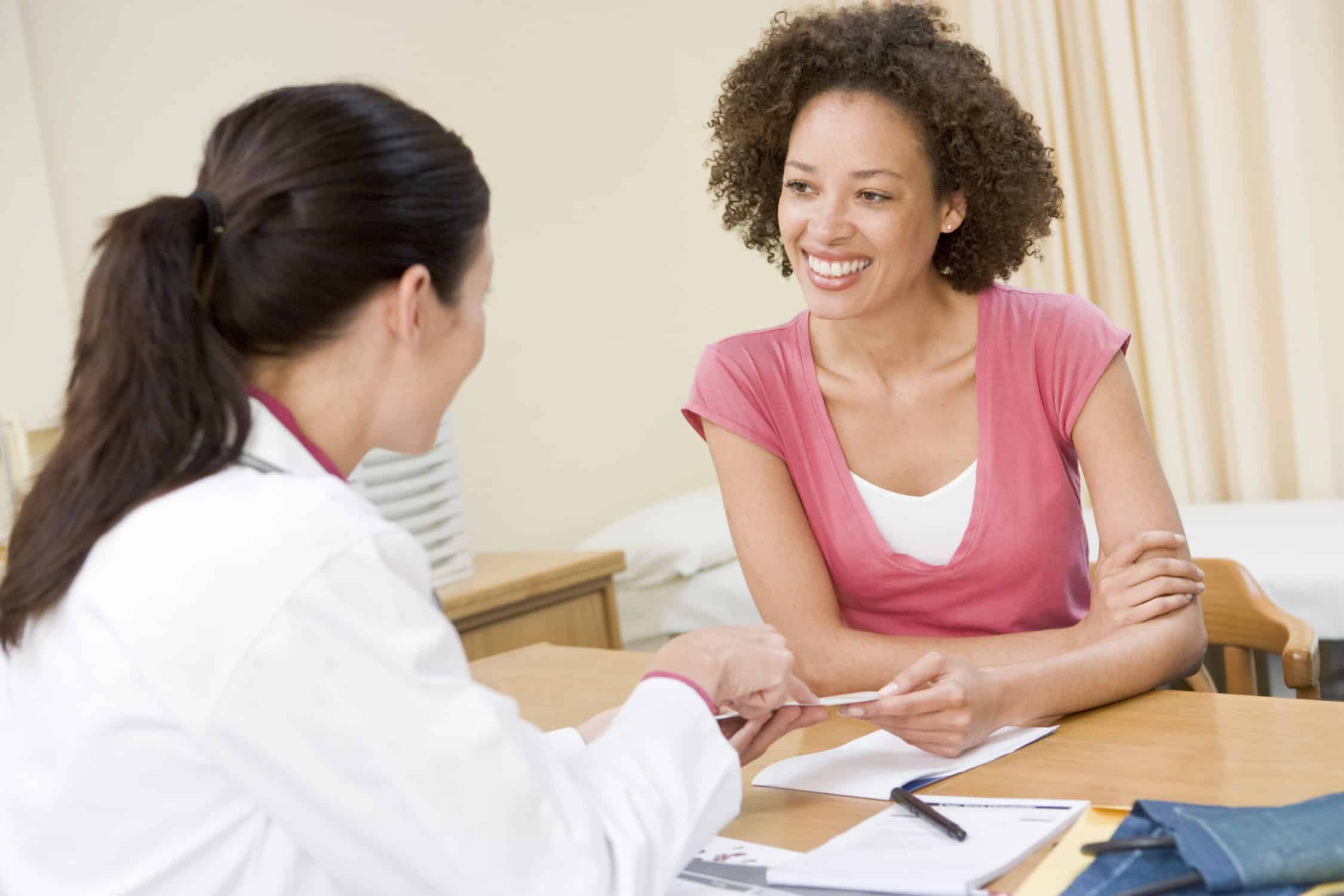 Woman smiling with doctor during office visit