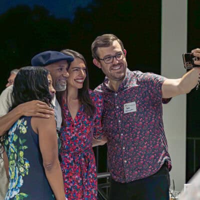 Group of four people gather for a selfie