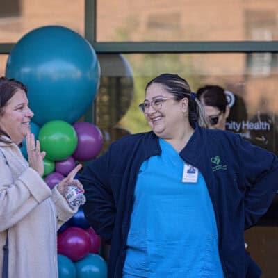 A nurse stands talking to another woman