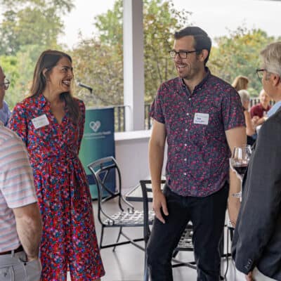 Group of 4 stand in a circle speaking