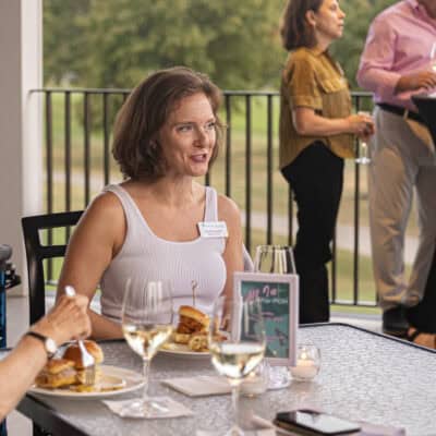 Woman sits at table listening patently