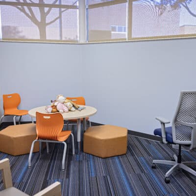 Private Children's Therapy Room with calm colors and child sized furniture, toys, and fidgets