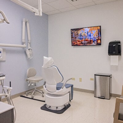 Calm spacious dental suite with a tv and an accessible dental chair