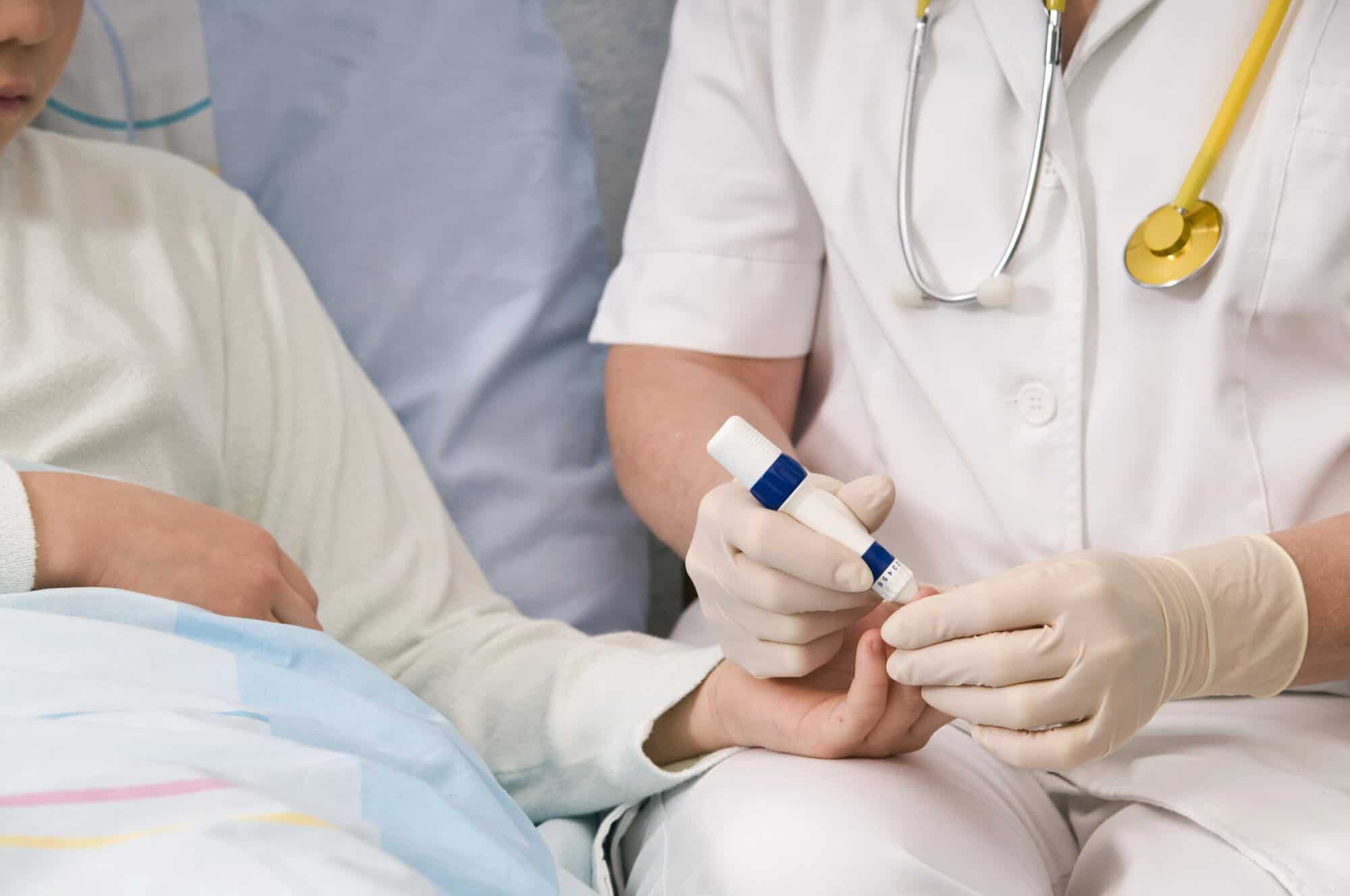 Nurse administering blood sugar test