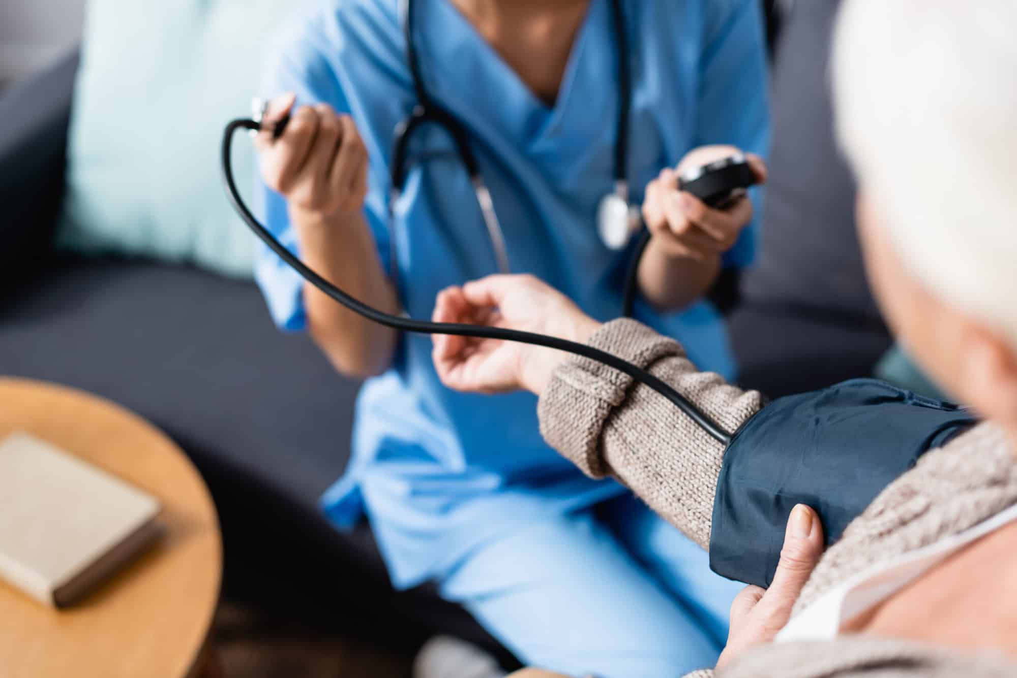 Nurse measuring patient's blood pressure