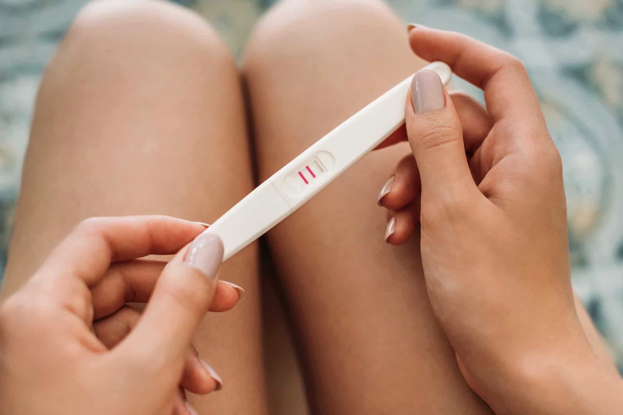 Hand holding pregnancy test