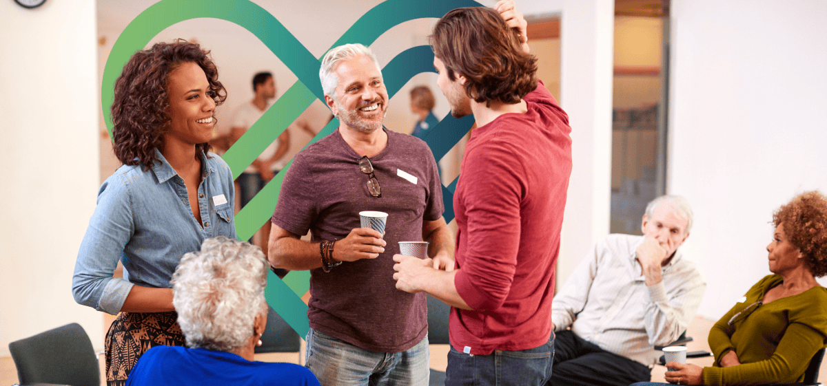 A small group in conversation in a social setting, reflecting collaboration and participation on the Community Advisory Board.