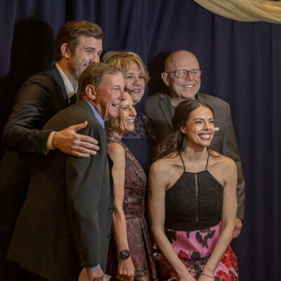 A group of guests smiles while posing for a photo at the gala photo booth.