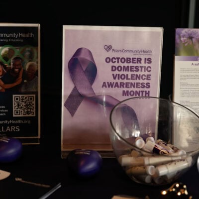 Awareness Table with sign saying "October is Domestic Violence Awareness Month"