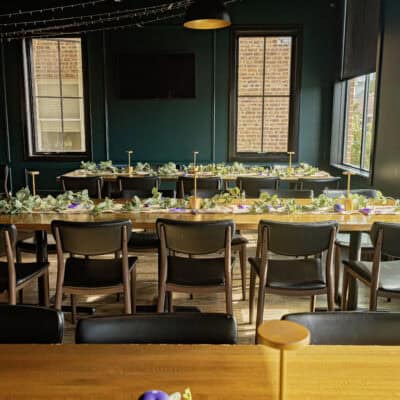 Room with windows and three long communal tables