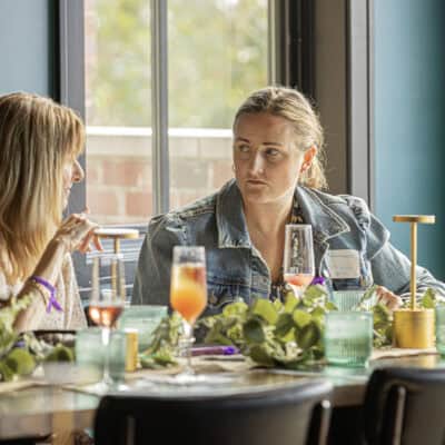 Two People talk over a breakfast table